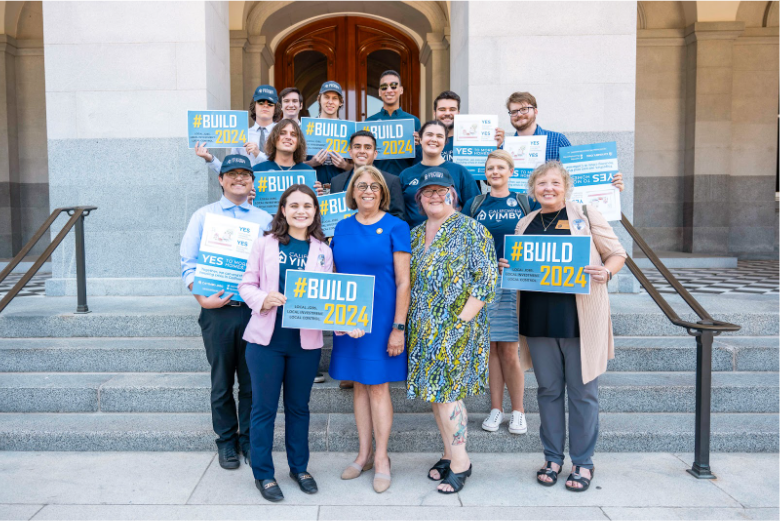 A team of activists holding blue #Build2024 signs.