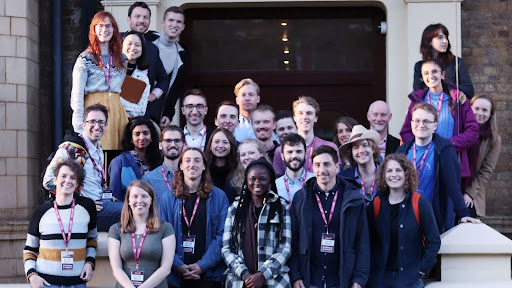 A group of just over 30 people, smiling at the camera
