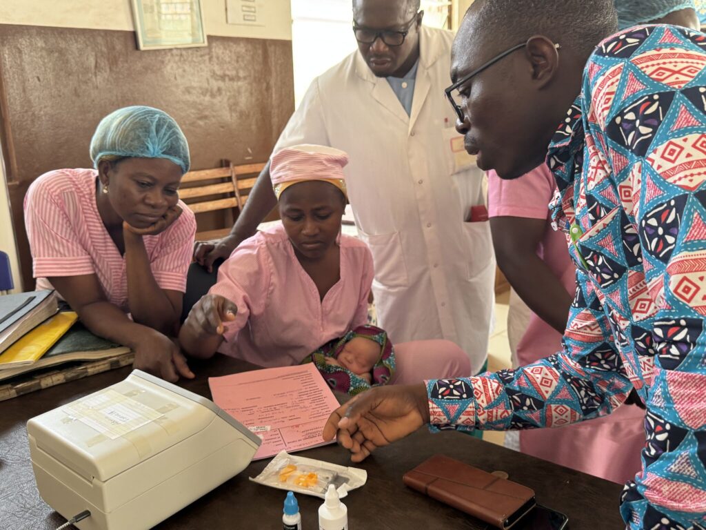 Medical professionals use the Gazelle reader to test a newborn for sickle cell disease.