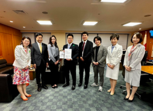 A group of well-dressed professionals pose for a photograph.